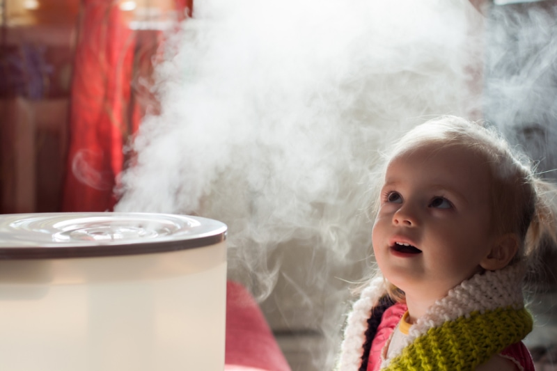 little girl looking at humidifier