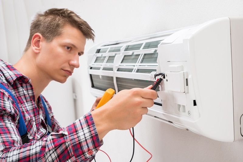 man fixing an hvac system